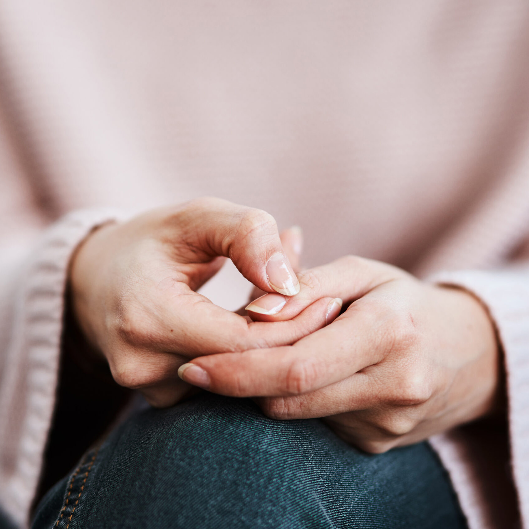 Cropped shot of a woman sitting on a sofa and feeling anxious